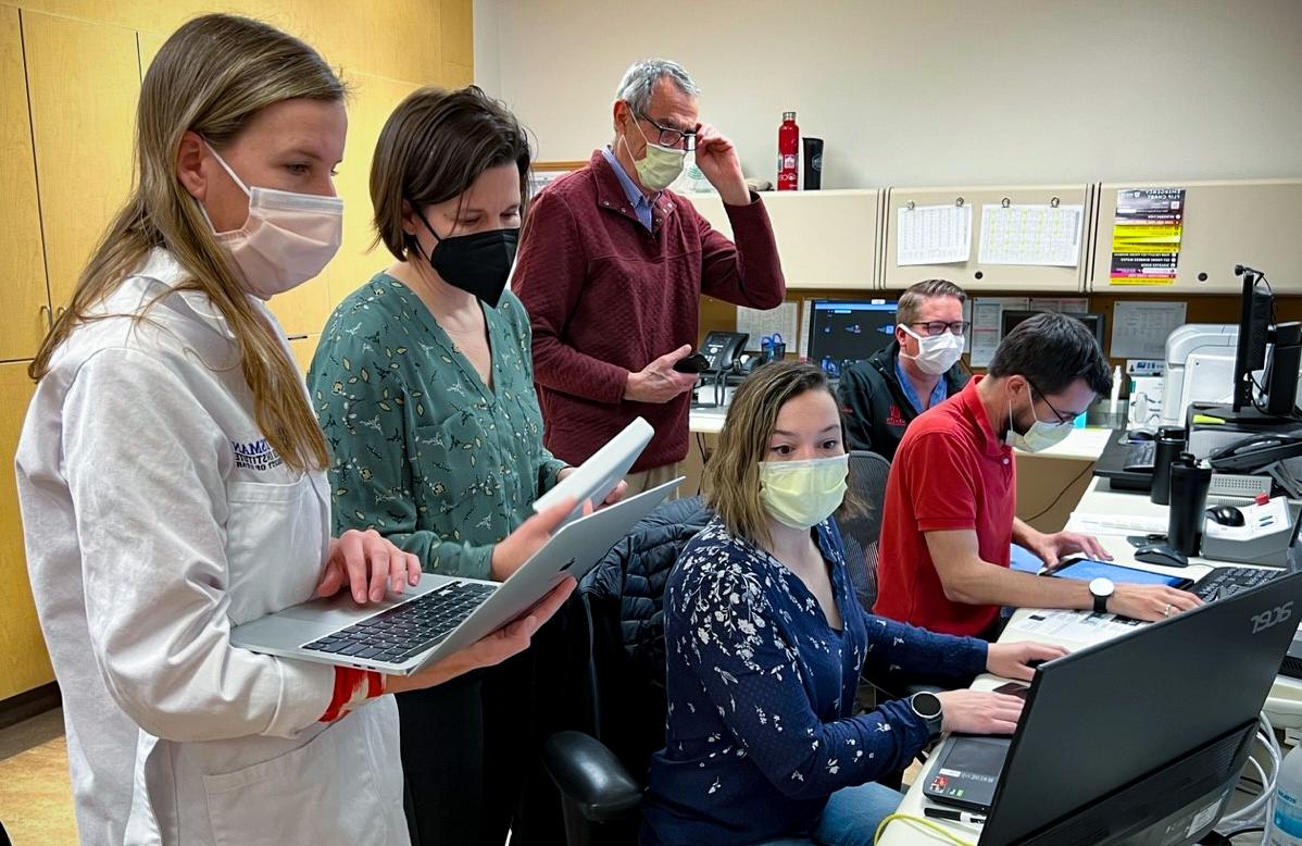 The research team in the MRI control suite: (seated, left-to-right) Henrik Odéen, PhD, Derek Maxfield, Sara Johnson, PhD, (standing, left-to-right) Dennis Parker, PhD, Allison Payne, PhD, and Nicole Winkler, MD.